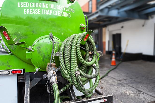 technicians pumping out a commercial grease trap in Atoka